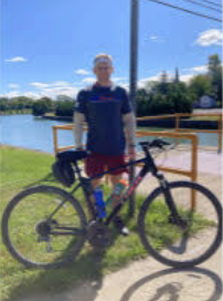 Photo of Kurtiss Driscoll standing with his bike for 100 mile ride. 