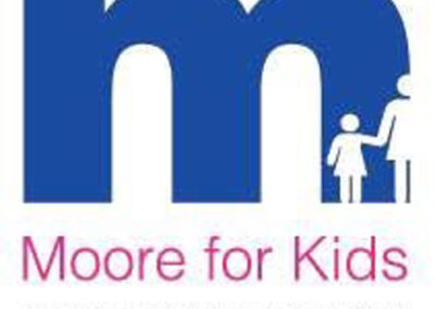 Blue “M” logo containing silhouettes of an adult and child holding hands, with pink text “Moore for Kids” and gray text “The Robert & Kristi Moore Foundation” on white background.